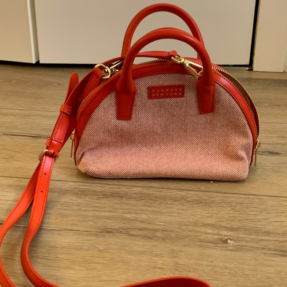 Purse with handle and strap.